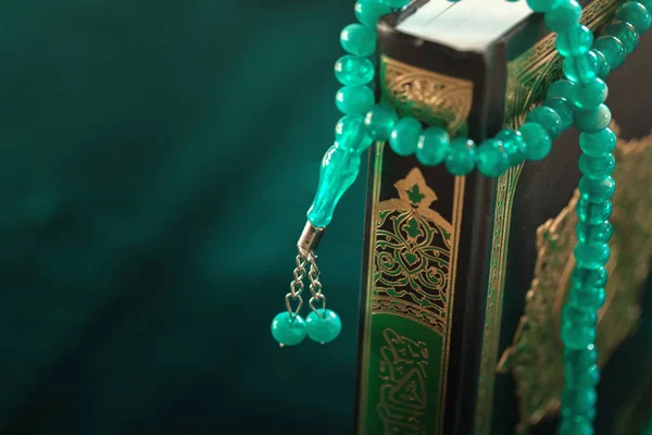 Muslim prayer beads on wooden background close up