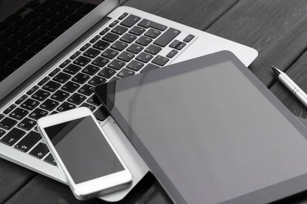 stock image Open laptop with digital tablet and smartphone close up