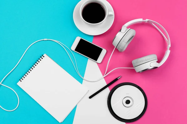 Headphones with cord on a bright color block background