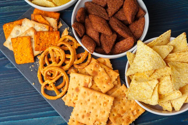 wide selection of snacks for beer on wooden background