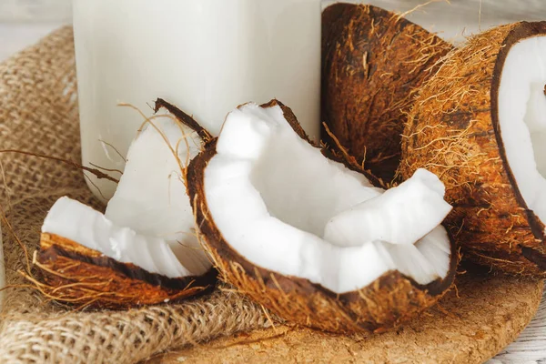 Coconut and coconut milk on rustic wooden table