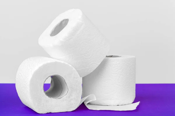 Rollos Papel Higiénico Aislados Sobre Mesa Blanca Con Fondo Púrpura — Foto de Stock