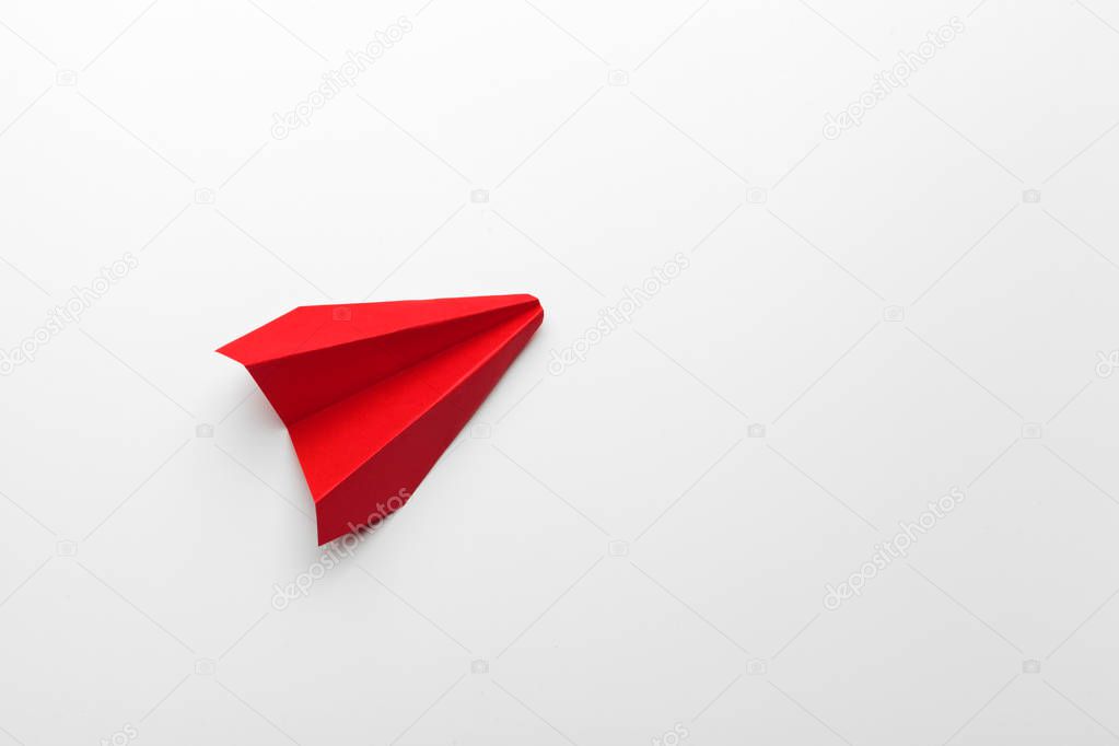 Red paper origami plane. Transportation and business concept