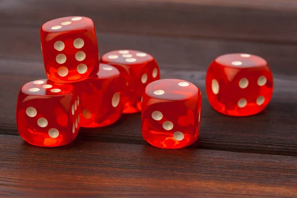 Dice on wooden table. Background for casino games.