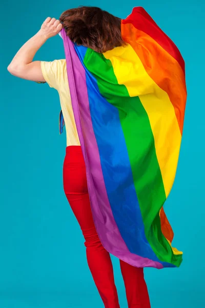 Rainbow flag. Woman holding and waving large LGBT flag