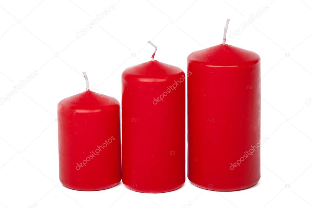 A selection of red candles on a white background