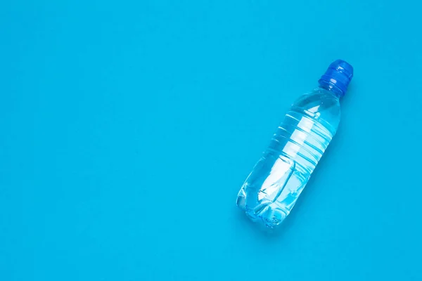 plastic water bottles with caps of different colour on the  table