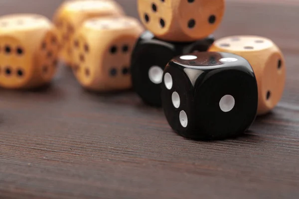 Dice on wooden table. Background for casino games.