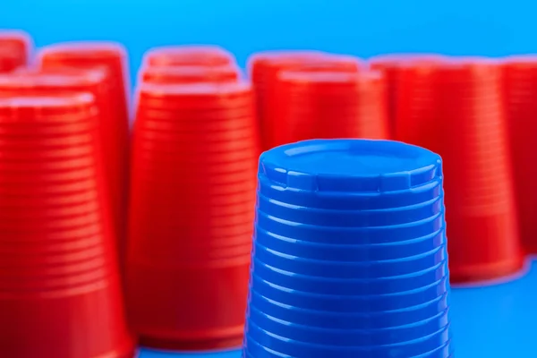 Beer pong, college party game. Plastic red and blue color cups