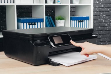 Fotokopi makinesiyle fotokopi çeken kadın.