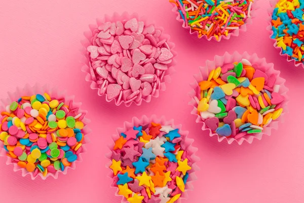 Sugar sprinkles  food background on pink cardboard