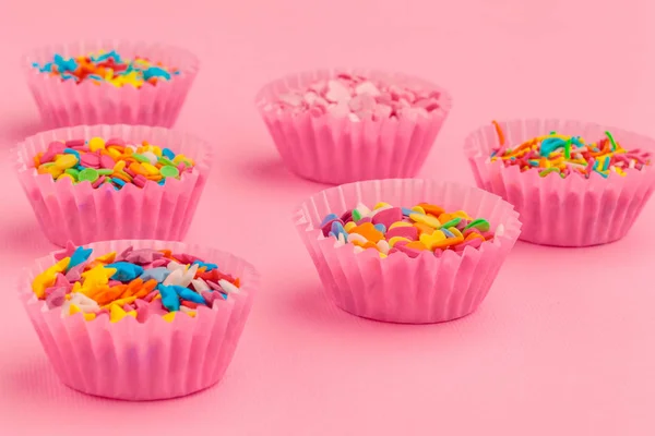 Sugar sprinkles  food background on pink cardboard