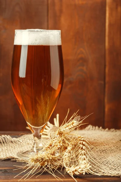 Glass beer on wood background