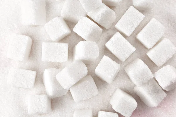 Cubes of sugar on bright pink background