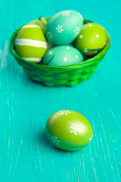 Green Easter eggs on wooden table