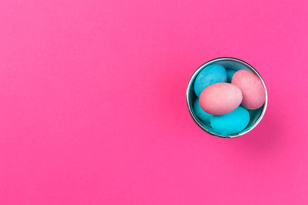 Colorful easter painted eggs on pink background