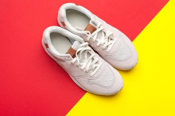 Pair of sport shoes on colorful background. New sneakers