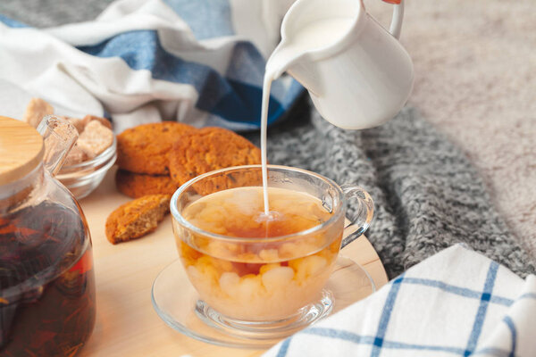 Hot masala chai, tea with milk poured over close up