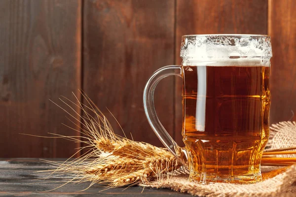 Glass beer on wood background