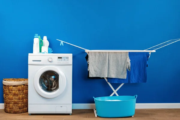 Laundry room interior with washing machine and clothes dryer near wall — Stock Photo, Image