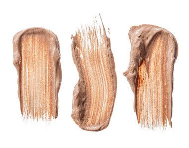 Krem bazlı lekeler beyaza izole edilmiş.