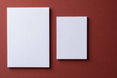 Burgundy kağıt arka planında boş beyaz kartvizitler