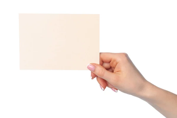 Kvinnlig hand som håller blankt vitt papper isolerat på vitt — Stockfoto