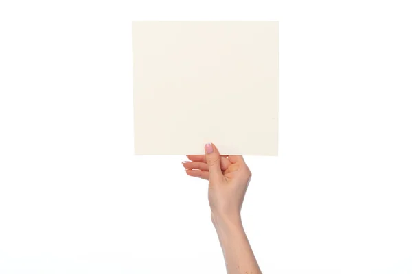 Female hand holding blank white sheet of paper isolated on white — Stock Photo, Image