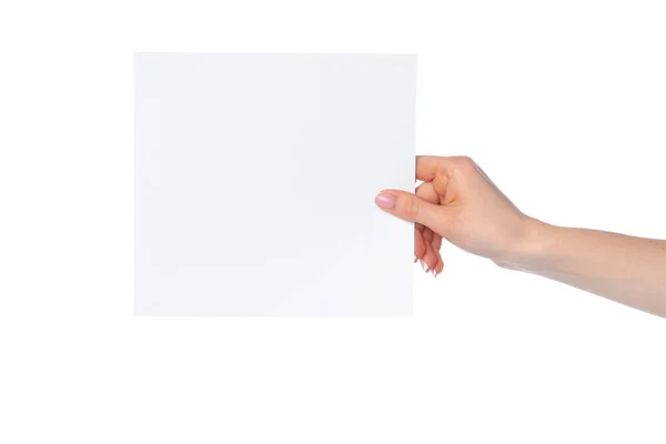 Žena ruka ukazující bílý papír banner izolované na bílém — Stock fotografie
