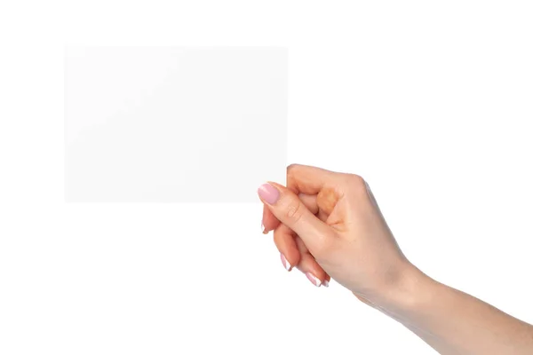 Frauenhand hält leeres weißes Blatt Papier isoliert auf weißem Papier — Stockfoto