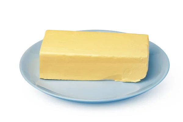 Máslo na bílém talíři izolované na bílém pozadí — Stock fotografie