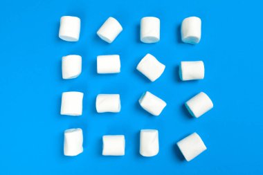 Marshmallows on blue background. close up. creative photo.