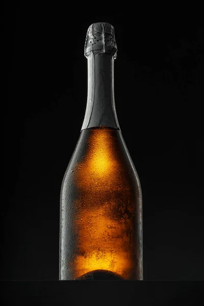 Champagne bottle on black background, copy space — Stock Photo, Image