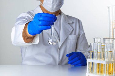 Laboratuvar örnekleriyle çalışan bir bilim adamının ellerine yakın çekim