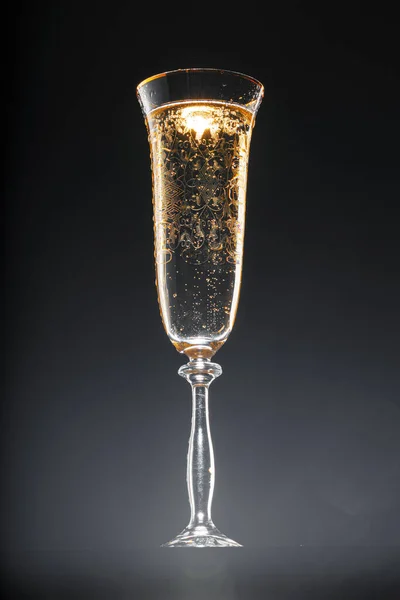 Glass full of champagne on black background — Stock Photo, Image