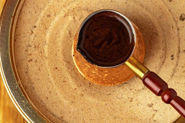 Turkish coffee in cezve on the sand — Stock Photo, Image