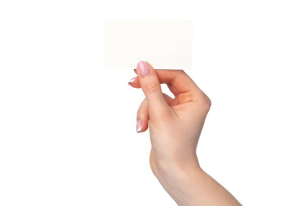 Schöne weibliche Hand mit weißer Visitenkarte auf weißem Hintergrund — Stockfoto