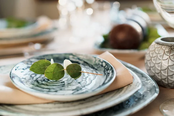 Beautiful elegant table setting with green stylish dishware and silver cutlery — Stock Photo, Image