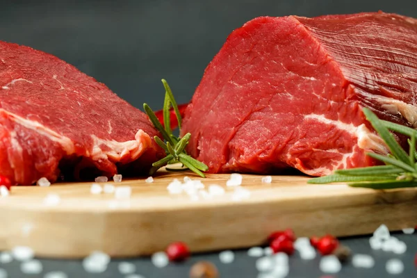 stock image Slice of raw beef fillet on wooden board