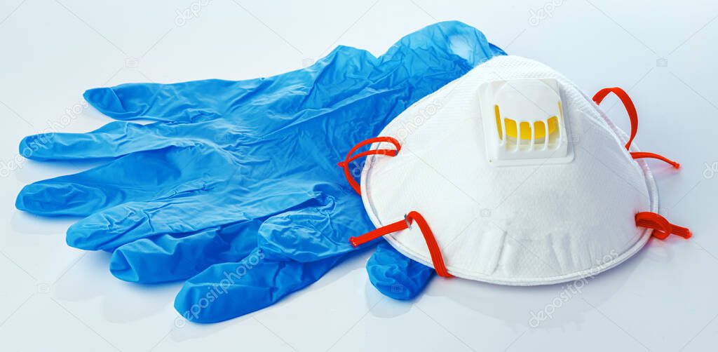 Medical masks with sterile latex gloves on white background