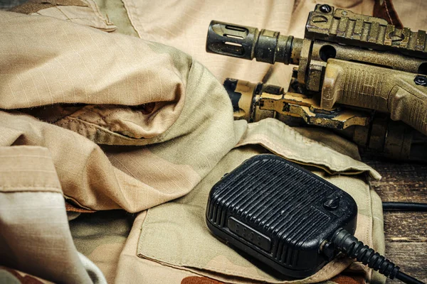 Military equipment, walkie-talkie with military uniform on wooden board — Stock Photo, Image