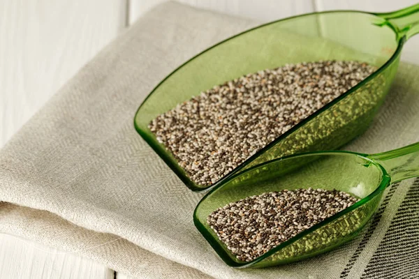 Chia seeds in green plastic scoop on table — Stock Photo, Image