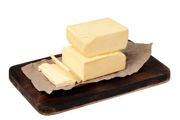 Beurre sur panneau de bois isolé sur fond blanc — Photo