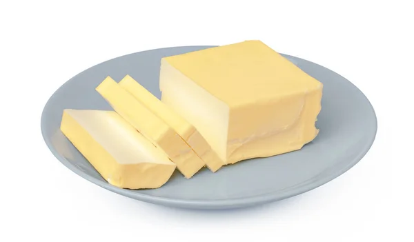 Máslo na bílém talíři izolované na bílém pozadí — Stock fotografie