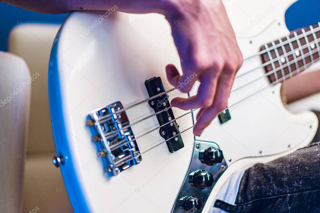 Close up photo of male hands playing guitar