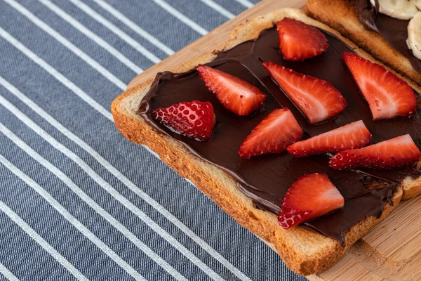 Sandwich toast with chocolate paste and cut strawberry