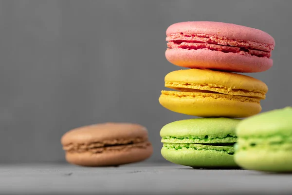 Biscoitos de macaroon coloridos na superfície cinza de perto — Fotografia de Stock