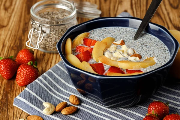 Bowl of chia poudding with pieces of apricots and strawberry — Stock Photo, Image