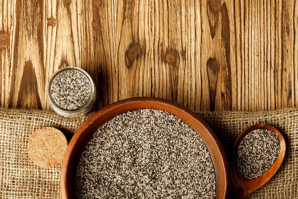 Chia seeds in a bowl with wooden spoon — Stock Photo, Image