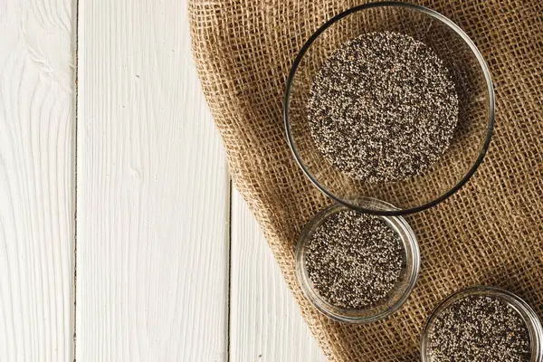 Glass bowl with chia seeds on wooden table — Stock Photo, Image